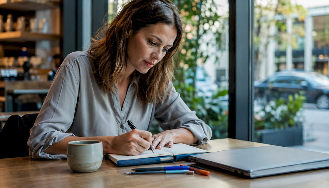 Woman writing vision statement at home table