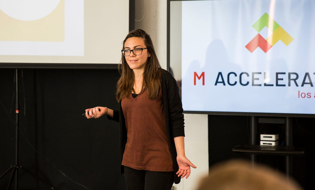 a woman standing in front of a projection screen