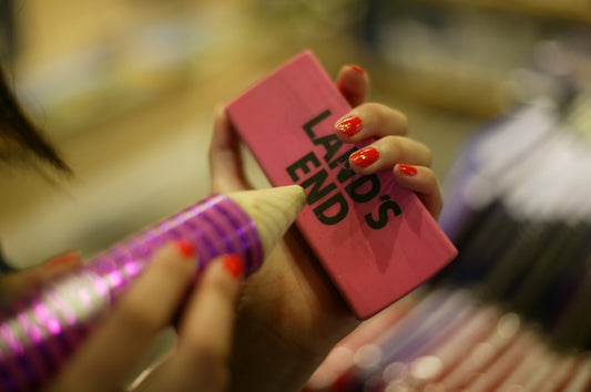 a woman holding a pink case with the words lead ends on it